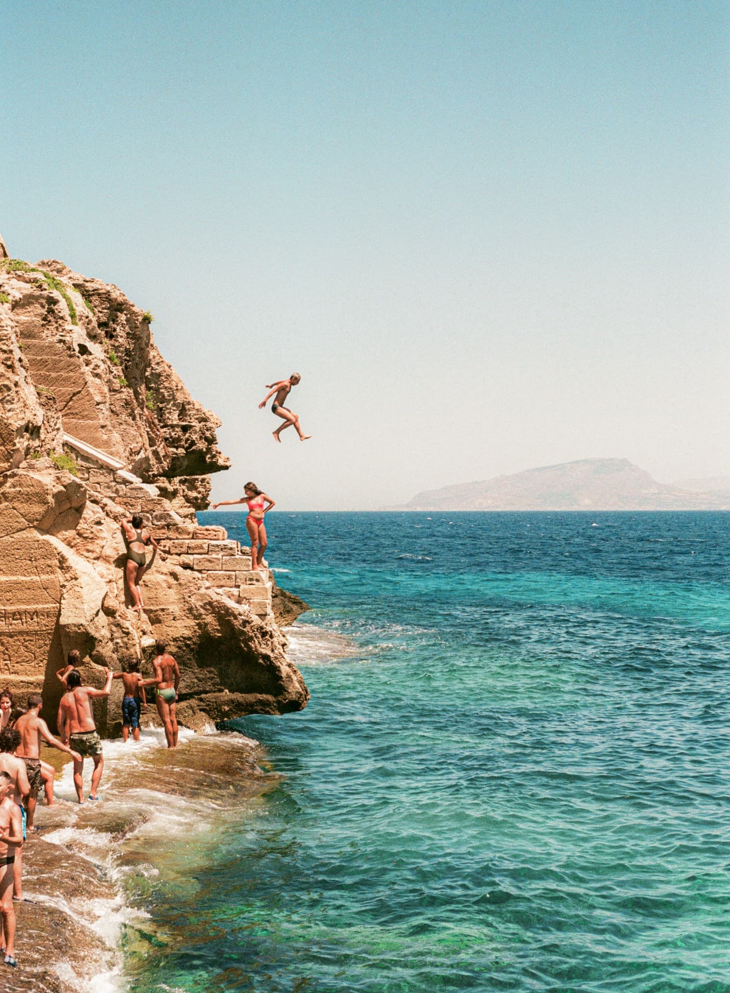 Barthelemy de Mazenod | The Seafront | A man jumping in the water in Favignana, Sicily
